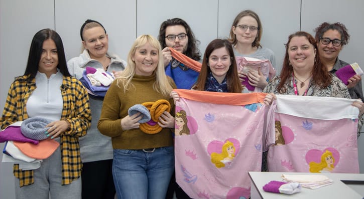 Students display blankets made for rescued wildlife following bush fires.